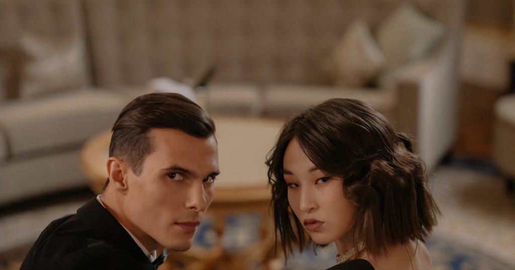 Apple cider vinegar bottle with fresh apples on wooden table