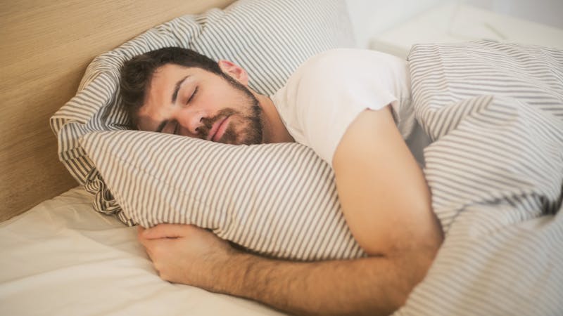 Person sleeping peacefully - quality sleep helps weight management