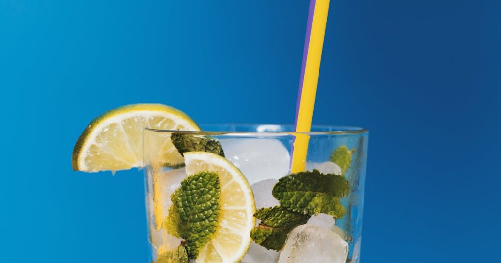 Glass of warm water with lemon on morning table