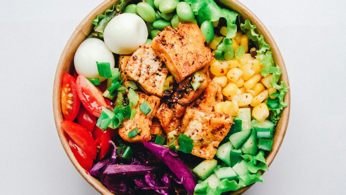 Plate with grilled salmon and avocado, both rich in omega-3 fatty acids that support skin barrier function.